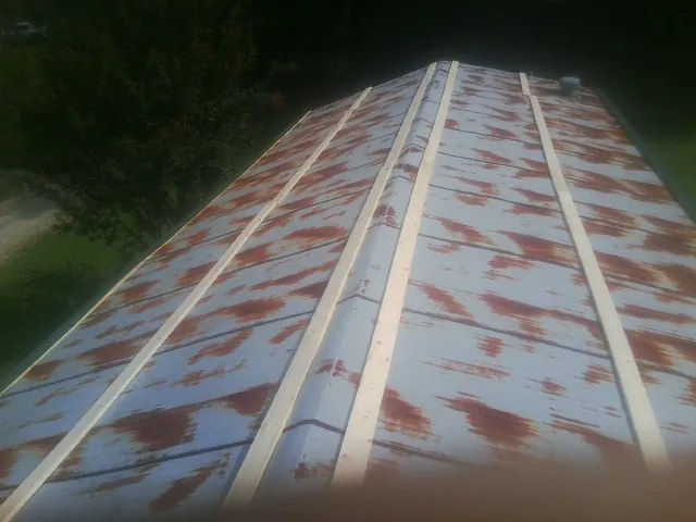 Rusted metal roof panels with new wood purlins before replacement — Storm Damage Roof Repair in Rimrock by Roofing Brothers