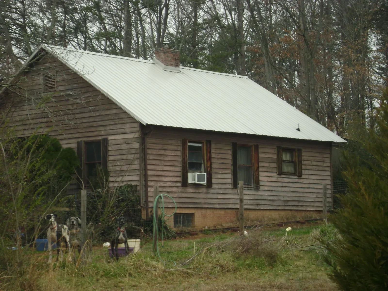 White metal roof on an old wood sided farmhouse, from a Metal Roof Installation job in Rimrock